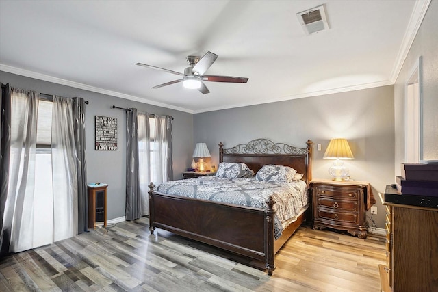 bedroom featuring ceiling fan, light hardwood / wood-style flooring, and crown molding