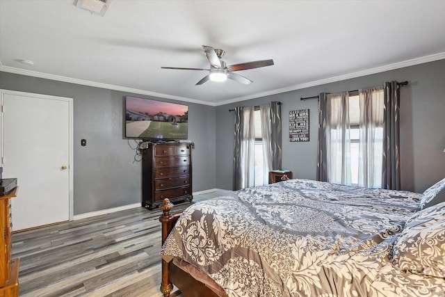 bedroom featuring ceiling fan, wood-type flooring, and crown molding