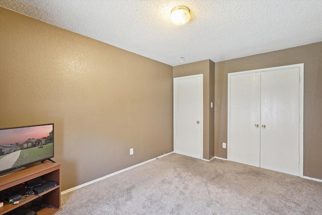 carpeted bedroom featuring a closet and a textured ceiling