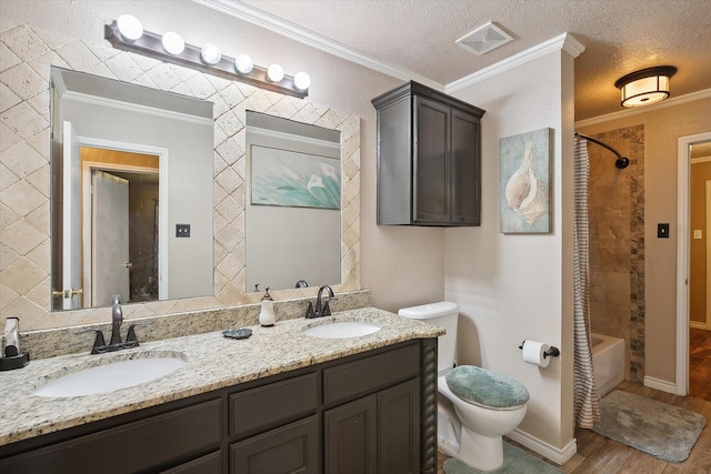 full bathroom with a textured ceiling, crown molding, and wood-type flooring