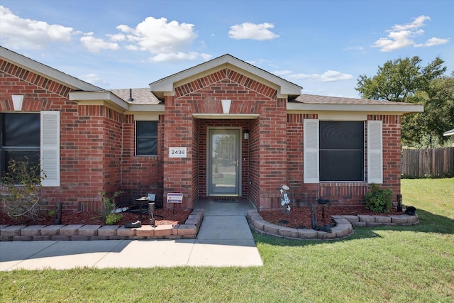 doorway to property featuring a yard