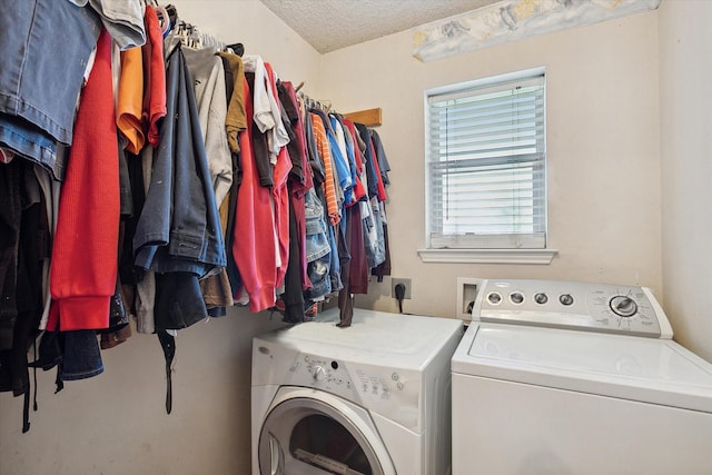 washroom featuring separate washer and dryer and a textured ceiling