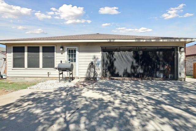 rear view of property featuring a garage