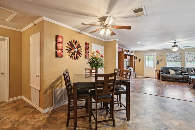 dining room featuring ceiling fan, a textured ceiling, dark hardwood / wood-style floors, and ornamental molding