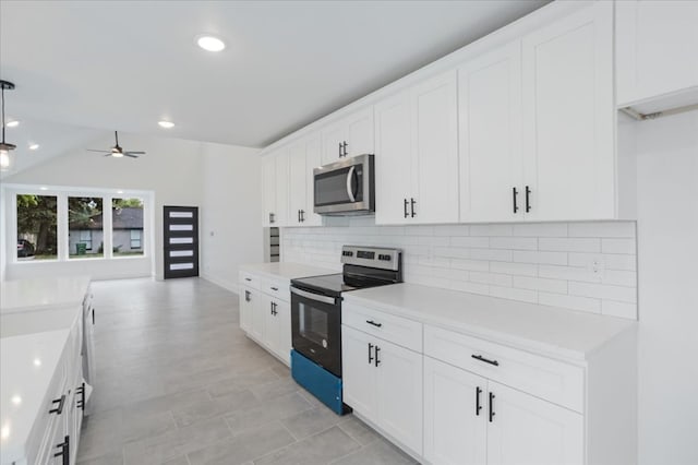 kitchen with ceiling fan, white cabinetry, appliances with stainless steel finishes, and tasteful backsplash