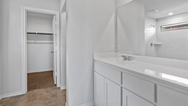 bathroom with a shower, tile patterned floors, and vanity