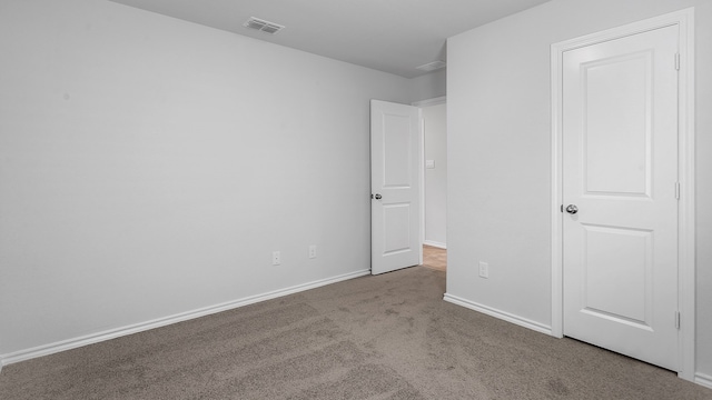 unfurnished bedroom featuring light carpet