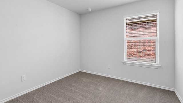 carpeted spare room with a healthy amount of sunlight