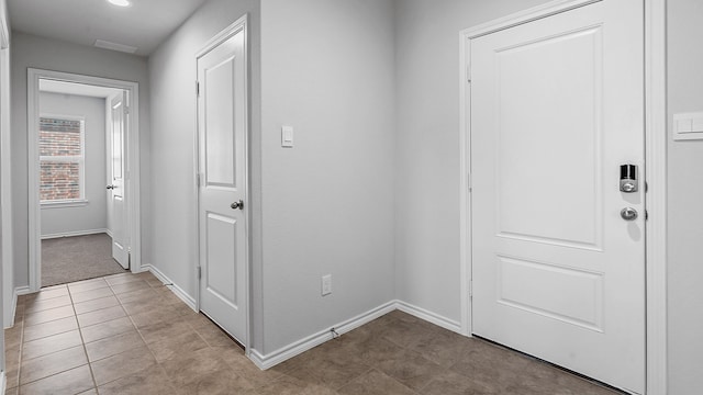 hall with light tile patterned floors