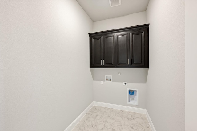 clothes washing area with cabinets, hookup for an electric dryer, hookup for a gas dryer, and hookup for a washing machine