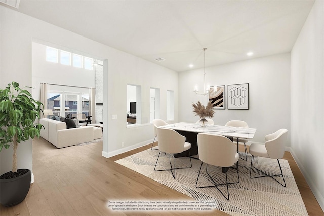 dining room featuring a chandelier and light hardwood / wood-style flooring