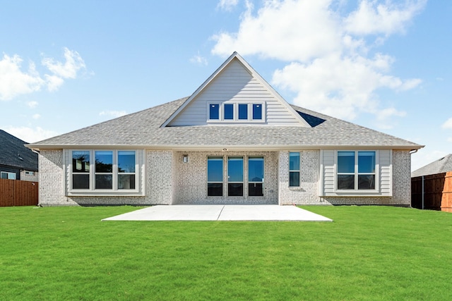 rear view of house with a yard and a patio