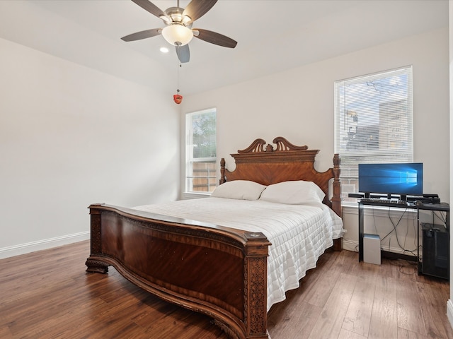 bedroom with dark wood-type flooring and ceiling fan