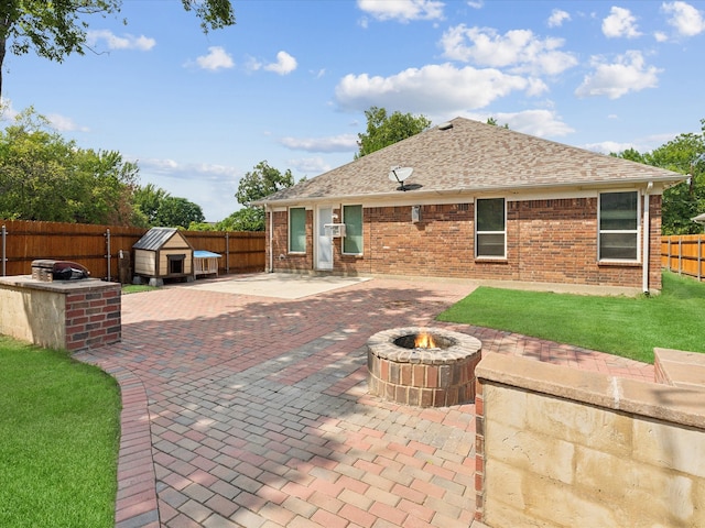 view of patio with a fire pit and a shed