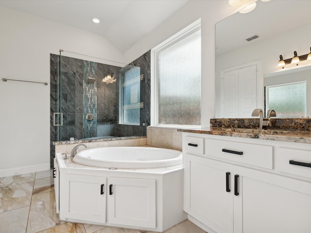 bathroom with lofted ceiling, vanity, a wealth of natural light, and independent shower and bath