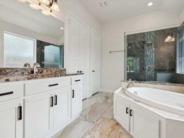 bathroom with lofted ceiling, vanity, and independent shower and bath