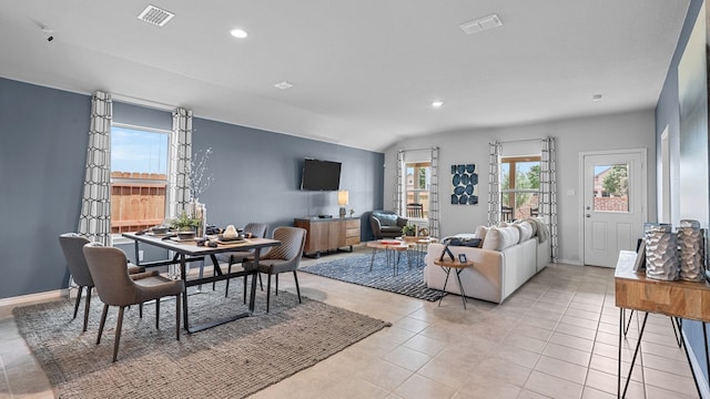 living room featuring lofted ceiling and light tile patterned floors