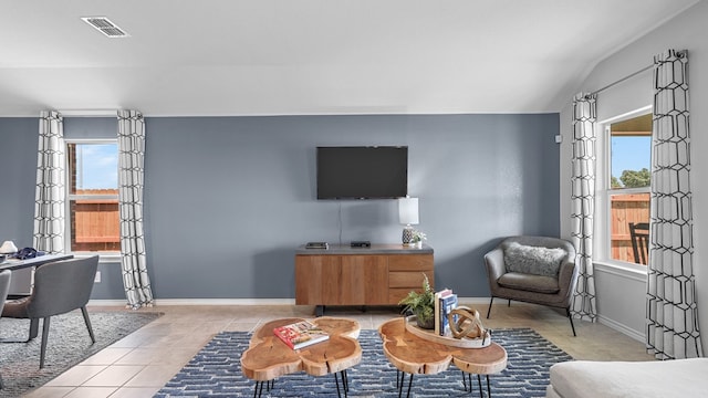 living room featuring lofted ceiling and light tile patterned flooring