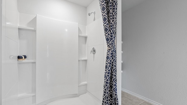 bathroom with tile patterned floors and walk in shower