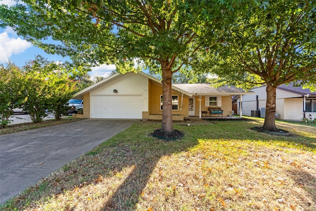 ranch-style home with a garage, central AC unit, and a front yard