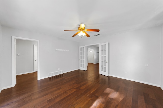 spare room featuring dark wood-type flooring, ceiling fan, and french doors