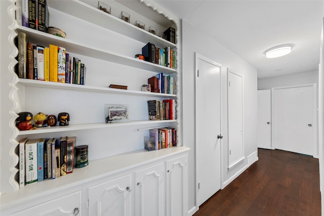 hallway with dark hardwood / wood-style floors