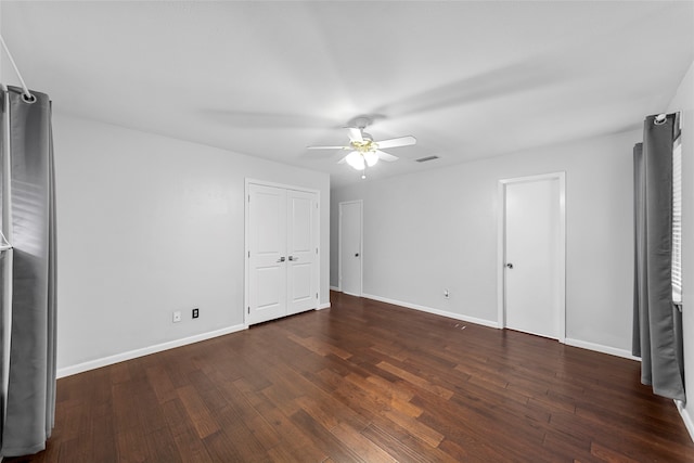 unfurnished bedroom with ceiling fan, dark hardwood / wood-style floors, and stainless steel refrigerator