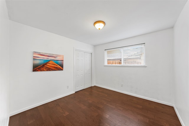 spare room featuring dark hardwood / wood-style flooring