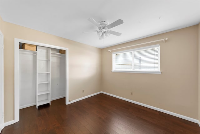 unfurnished bedroom with dark wood-type flooring, ceiling fan, and a closet