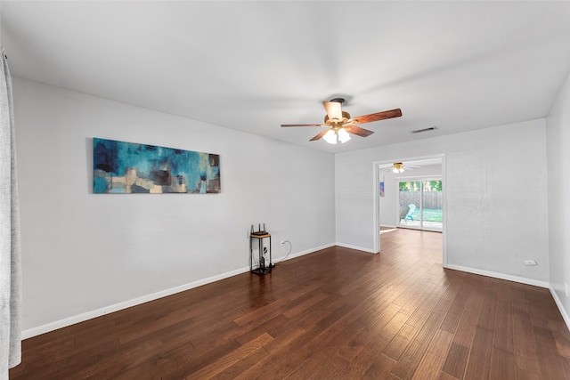 empty room with dark wood-type flooring and ceiling fan