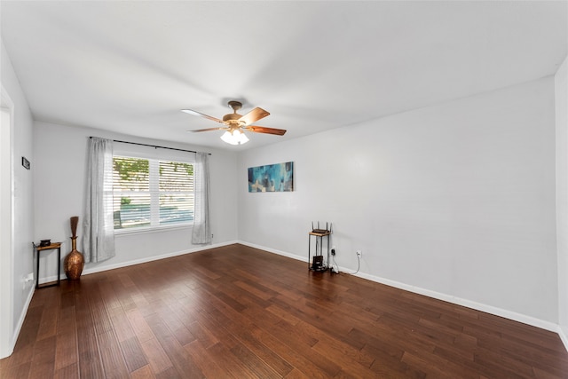 empty room featuring ceiling fan and dark hardwood / wood-style floors