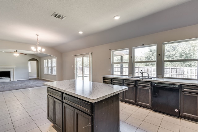 kitchen featuring ceiling fan with notable chandelier, decorative light fixtures, dishwasher, a center island, and sink