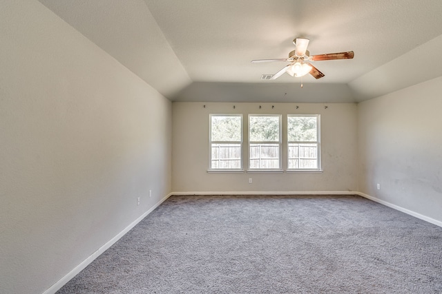 spare room featuring lofted ceiling, ceiling fan, and carpet floors