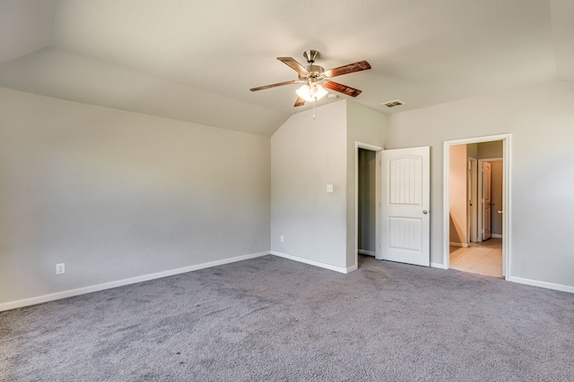 unfurnished bedroom with lofted ceiling, ceiling fan, and light carpet