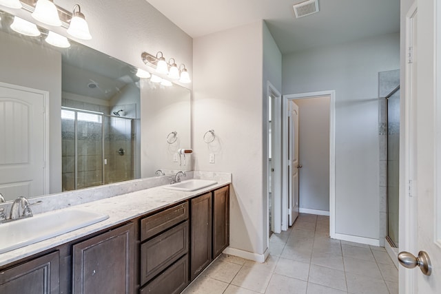 bathroom featuring a shower with shower door, tile patterned flooring, and vanity