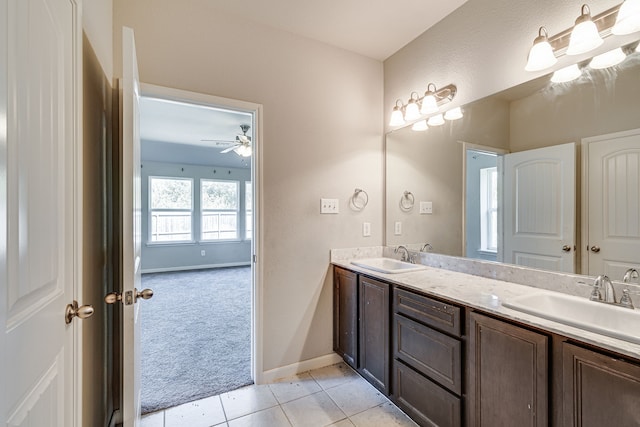 bathroom with tile patterned flooring, vanity, and ceiling fan