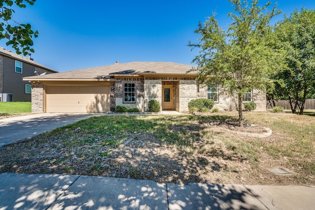 view of front facade featuring a front yard, a garage, and central AC unit