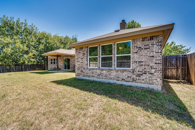 back of property featuring a lawn