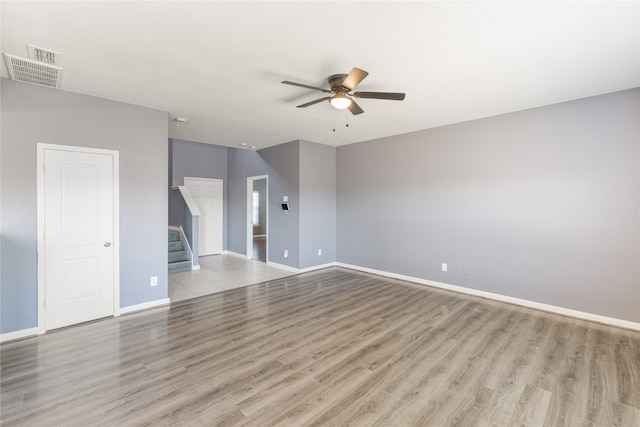 unfurnished living room featuring light wood-type flooring and ceiling fan