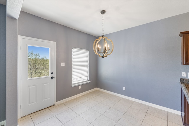 unfurnished dining area featuring a notable chandelier and light tile patterned flooring