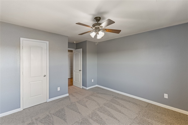 unfurnished bedroom with light colored carpet and ceiling fan