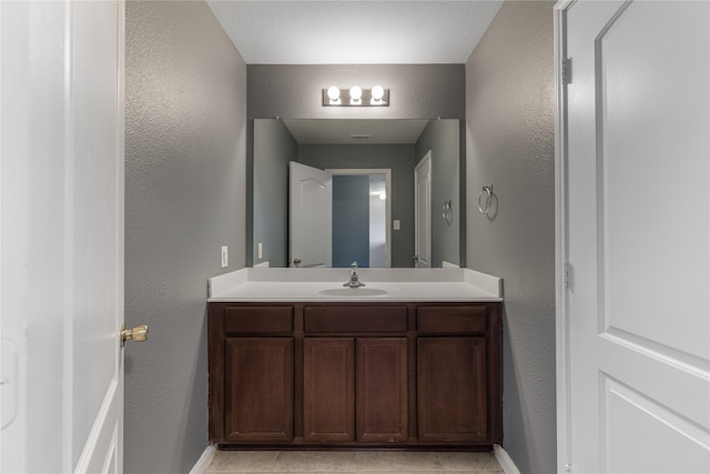 bathroom with vanity and tile patterned floors