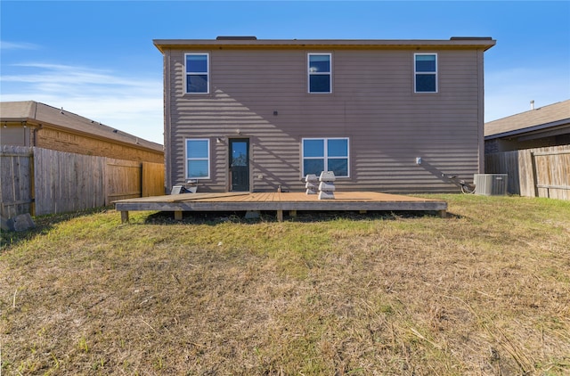 back of property featuring central air condition unit, a yard, and a wooden deck