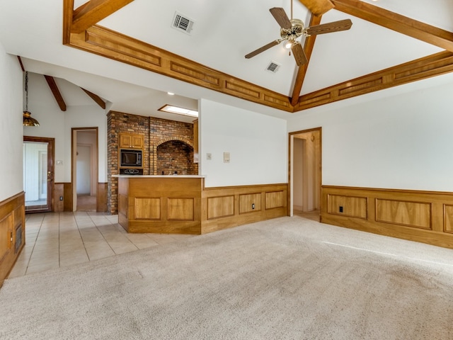 unfurnished living room featuring high vaulted ceiling, ceiling fan, light colored carpet, and beam ceiling