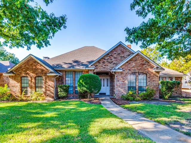 view of front of property with a front yard and french doors