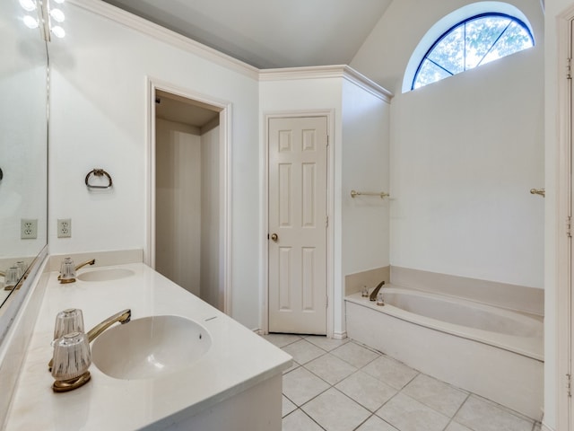 bathroom with a tub, vanity, and tile patterned floors