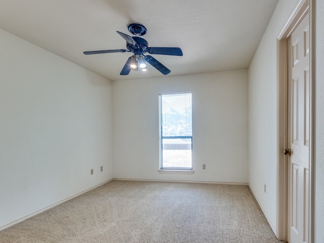 spare room featuring ceiling fan and light carpet