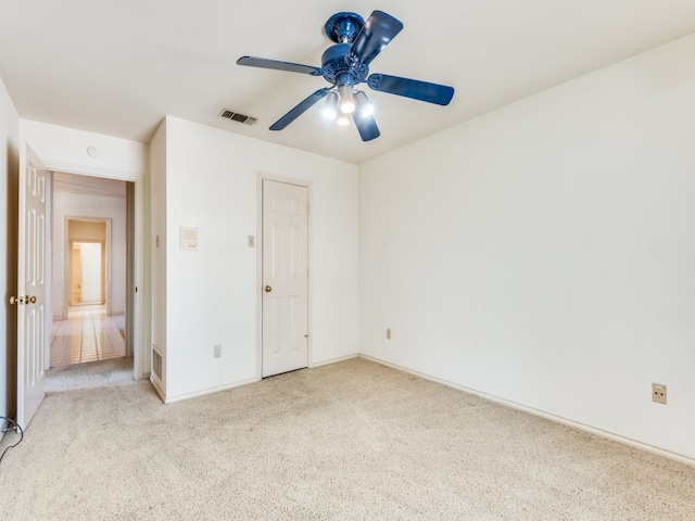 unfurnished bedroom with a closet, ceiling fan, and light carpet