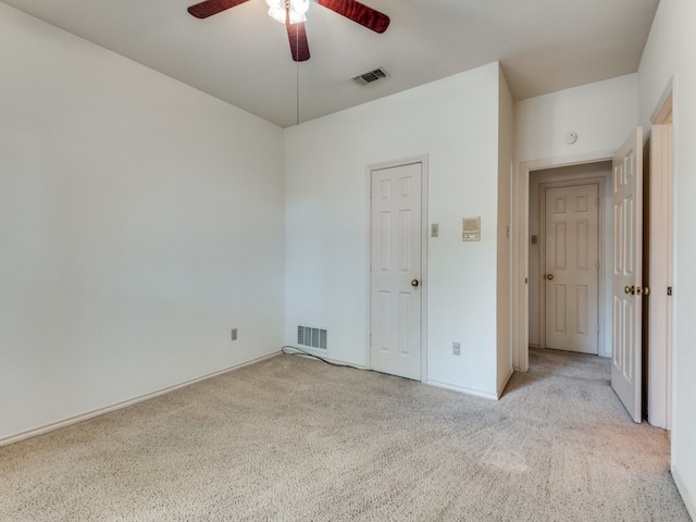 unfurnished bedroom featuring ceiling fan and light colored carpet