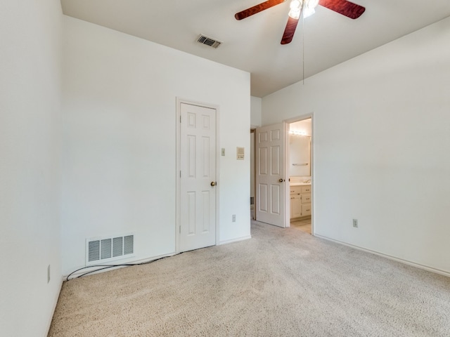 interior space featuring light colored carpet and ceiling fan